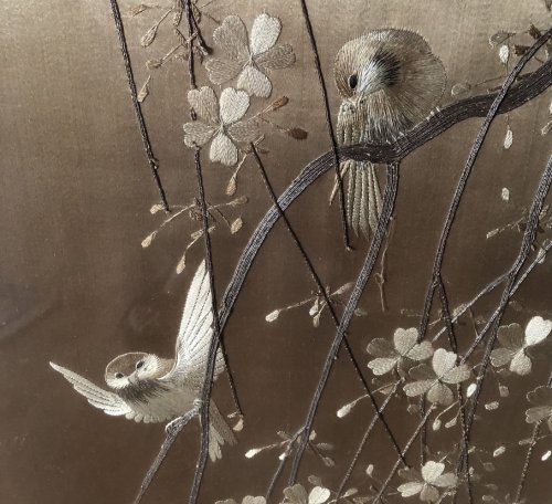 An embroidered scene of Birds and Cherry Blossoms.