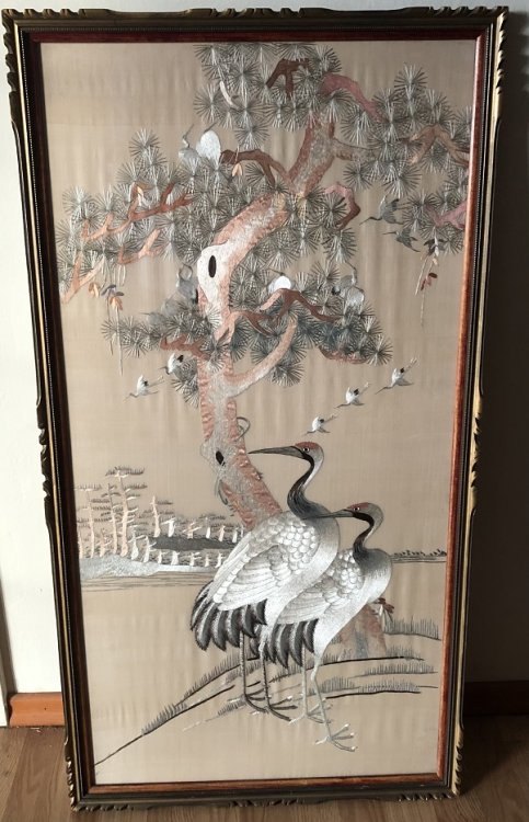 An embroidered scene of Two Herons Beneath a Tree.