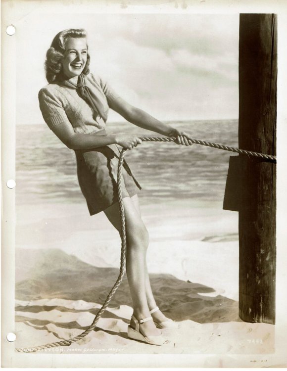 A VINTAGE PUBLICITY PHOTOGRAPH of the Hollywood Movie Star JUNE ALLYSON attired in fashionable shorts and sweater.