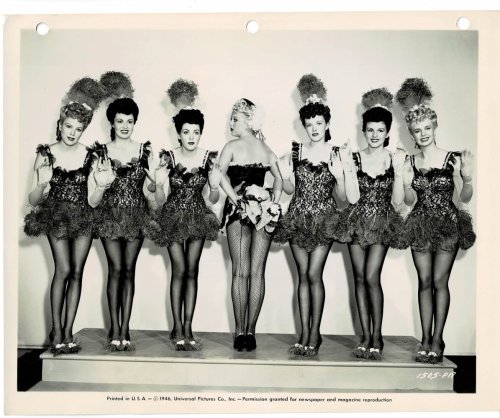A VINTAGE PUBLICITY PHOTOGRAPH of the Hollywood Movie Actress & Showgirl JOAN FULTON (aka JOAN SHAWLEE) with a line of chorus girls in 