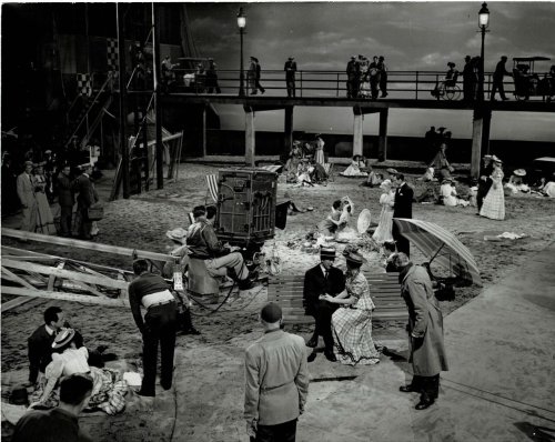 A VINTAGE PUBLICITY PHOTOGRAPH by EMMETT SCHOENBAUM depicting the cameraman, cast and crew on the stage set of 20th Century Fox's 