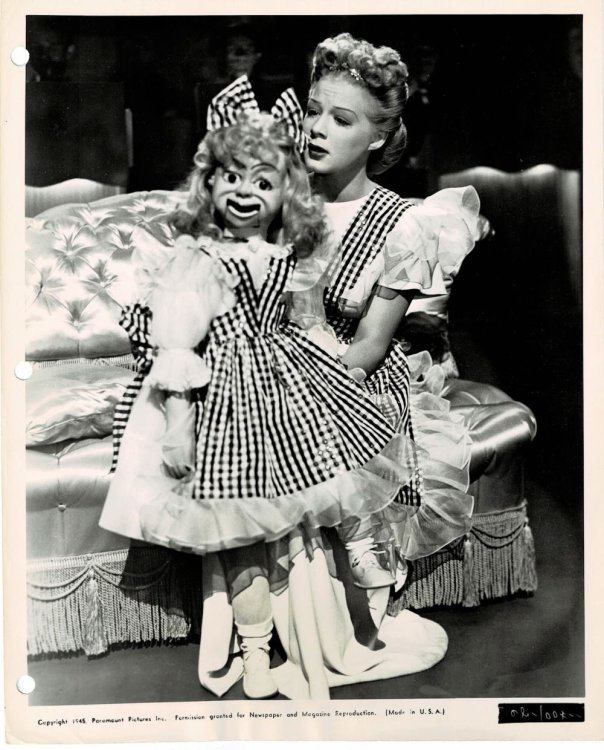 A VINTAGE PUBLICITY PHOTOGRAPH of Hollywood Actress BETTY HUTTON with her ventriloquist dummy in a musical scene from Paramount's 