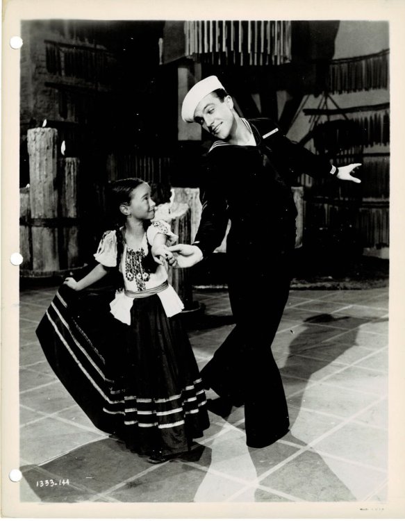 A VINTAGE PUBLICITY PHOTOGRAPH of Hollywood Movie Star & Dancer GENE KELLY dancing with 7 year old child actress SHARON McMANUS in a scene from ANCHORS AWEIGH.