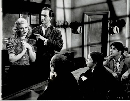 A VINTAGE CONTINUITY LAYOUT PHOTOGRAPH depicting BASIL RATHBONE instructing GINGER ROGERS at his school for pickpockets in a scene from 