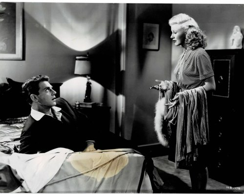 A VINTAGE CONTINUITY LAYOUT PHOTOGRAPH depicting GINGER ROGERS speaking with JEAN-PIERRE AUMONT as he's reclining on his hotel bed in a scene from 