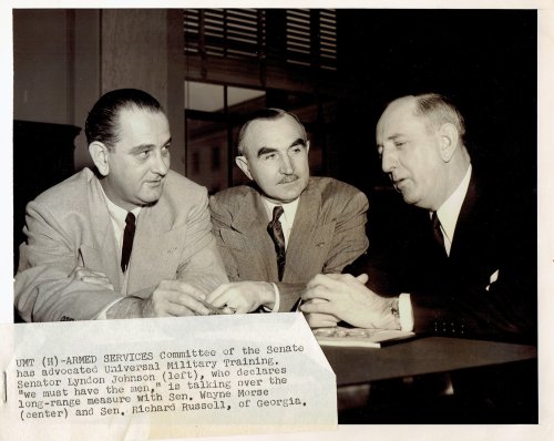 A WONDERFUL VINTAGE NEWS PHOTOGRAPH TAKEN CIRCA 1953-4 DEPICTING THEN-SENATOR LYNDON JOHNSON CHAIRMAN OF THE SENATE ARMED SERVICES COMMITTEE WITH SENATOR WAYNE MORSE AND SENATOR RICHARD RUSSELL OF GEORGIA.