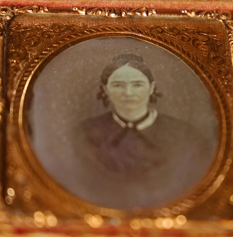 Daguerrotype Photo of Young Woman with Decorated Morocco Case Featuring Floral Design and Bearing Title of Memory's Leaflet
