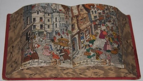 [Faux Book] Candy Box in the shape of an open book, with a colorful Parisian street scene depicted on its two open pages; La rue de l'Ecole de Medicine sous Louis XIV. La rue de la Ferronnerie sous Henry IV