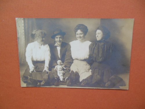 Real Photo Postcard Smiling Group Young Man with Two Dolls