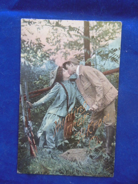 Postcard Hunting Near Akron, Ohio Couple Kissing, Rifles Next to Fence (1910)