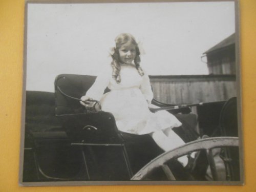Photograph Little Girl In Sunday Best In A Buggy (Early 1990's)