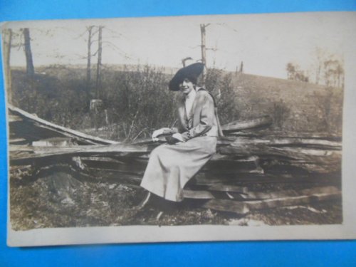 Real Photo Postcard. Lady Dressed up Sitting on Split Rails