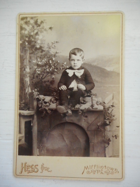 Serious Little Boy, John T. Leonard Sitting on a Pretend Fireplace, 1891