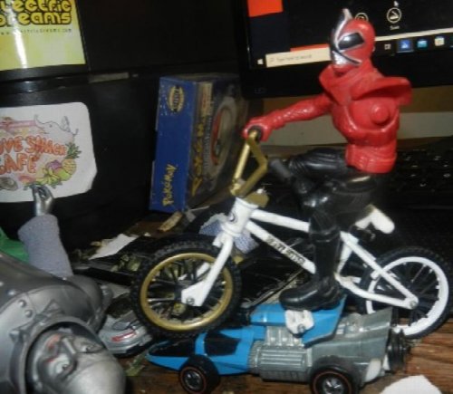 uncle Bob investigates weed plant on bicycle action figure