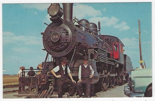 TWO AMISH BOYS RESTING ON THE OLD 98, STRASBURG RAIL ROAD, STRASBURG, PENNSYLVANIA