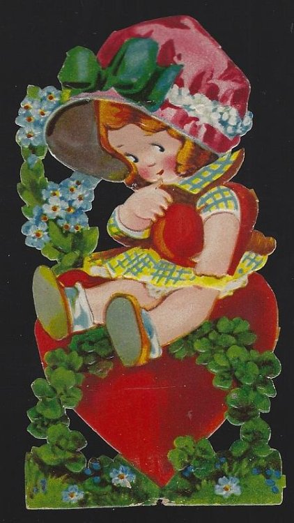 VICTORIAN DIE CUT CARD OF GIRL SITTING ON HEART AND HOLDING HEART
