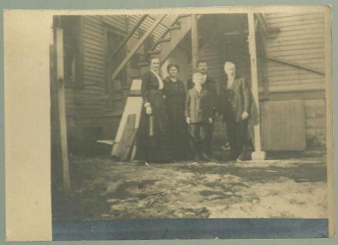 VINTAGE PHOTOGRAPH OF FAMILY STANDING ON BACK PORCH