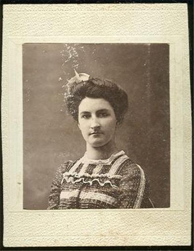 YOUNG WOMAN IN GINGHAM DRESS AND HAT