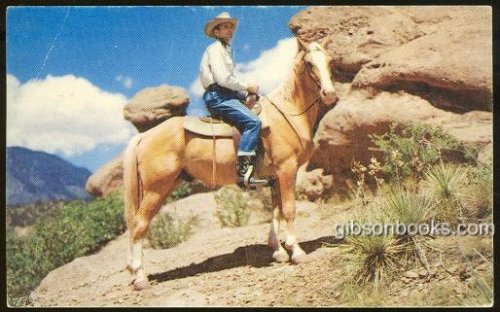 COWBOY ON HORSEBACK HALTED TO SURVEY THE SCENIC SPLENDOR