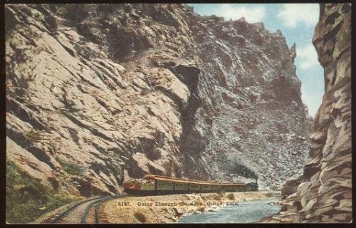 TRAIN GOING THROUGH THE ROYAL GORGE, COLORADO