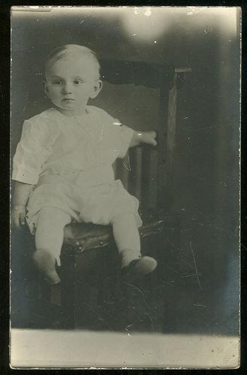 REAL PHOTO POSTCARD OF BABY BOY SITTING IN CHAIR