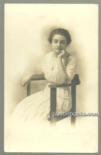 REAL PHOTO POSTCARD OF LOVELY LADY SITTING IN CHAIR