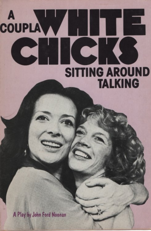 A COUPLA WHITE CHICKS SITTING AROUND TALKING
