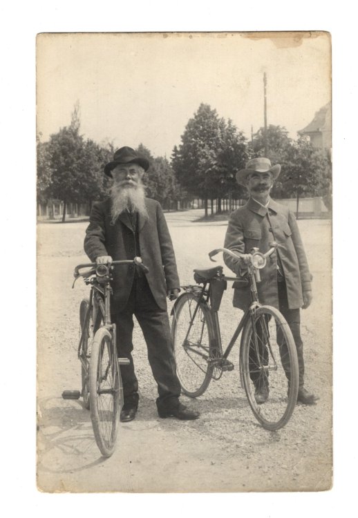 Photo Postcard of Two Oldtimers in Hats Posing with Bicycles, Early 1900s